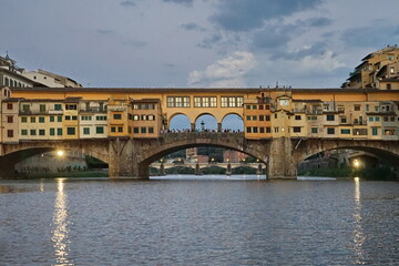Naklejka premium Ponte Vecchio at sunset seen from a boat on the Arno River in Florence, Tuscany, Italy
