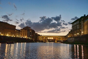 Naklejka premium Ponte Vecchio at sunset seen from a boat on the Arno River in Florence, Tuscany, Italy