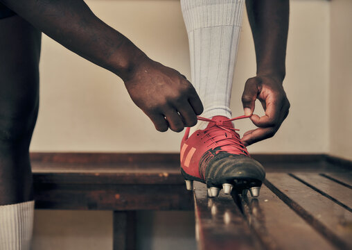 Rugby, tie shoes or hands of man ready to start playing a training game for exercise or workout. Zoom, fitness or Healthy athlete player with footwear or boots in changing room or sports club bench