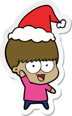 happy sticker cartoon of a boy waving wearing santa hat