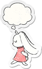 cute cartoon rabbit and thought bubble as a distressed worn sticker
