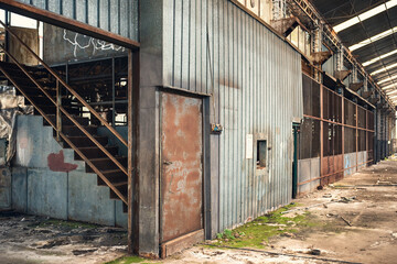 Fototapeta na wymiar interiors and machinery, plants retaking possession of a disused abandoned industry, former cotton mill, industrial production