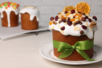 Tasty Easter cakes with dried fruits and nuts on white wooden table. Space for text