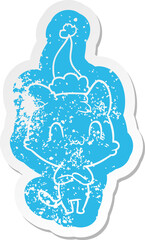 cartoon distressed sticker of a happy cat wearing santa hat