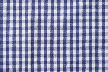 Blue checkered tablecloth as background, top view