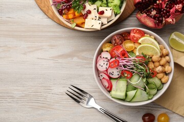 Bowl with many different vegetables on white wooden table, flat lay and space for text. Vegan diet