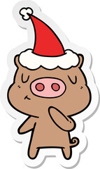 sticker cartoon of a content pig wearing santa hat