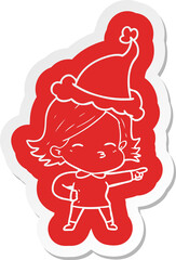 cartoon  sticker of a woman pointing wearing santa hat