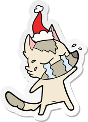 sticker cartoon of a crying wolf wearing santa hat