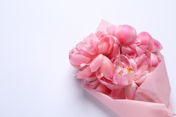 Beautiful bouquet of pink peonies on white background, top view