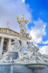 Naklejka premium Vienna, Austria, statue and fountain of Pallas Athena, Parliament building in austrian capital