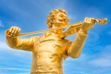 Vienna, Austria golden close-up statue of music composer Johann Strauss, playing the violin, in the...