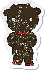 retro distressed sticker of a cartoon little black bear