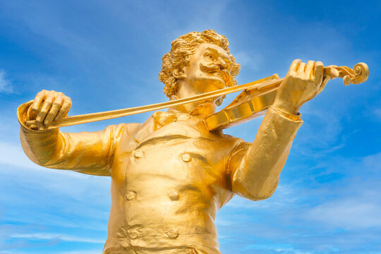Vienna, Austria golden close-up statue of music composer Johann Strauss, playing the violin, in the Stadtpark park