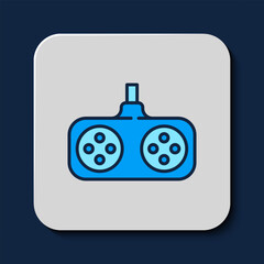 Filled outline Gamepad icon isolated on blue background. Game controller. Vector