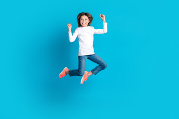 Full size photo of overjoyed ecstatic girl wear white long sleeve denim trousers jump celebrate...