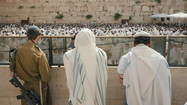 Jewish men praying at Western Wailing Wall in Jerusalem Israel on Sukkot holiday