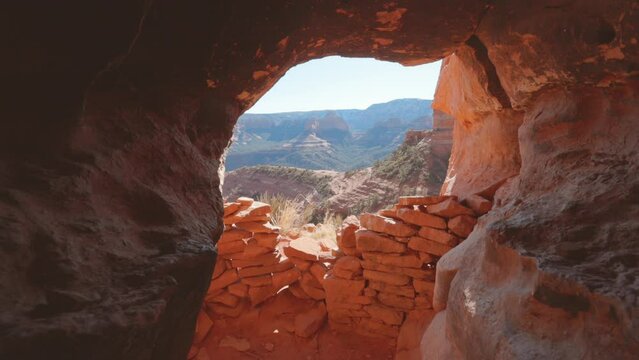 Inside view of cave in Sedona showing ancient ruins stacked at the entrance.