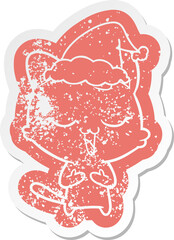 happy cartoon distressed sticker of a cat wearing santa hat