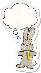 cartoon rabbit and thought bubble as a distressed worn sticker