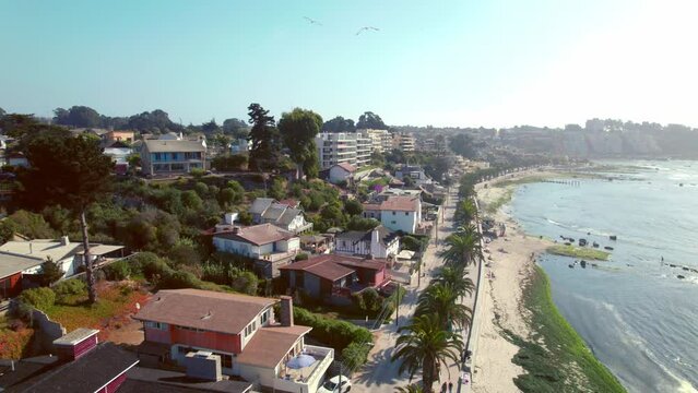 Slow motion aerial shot of seafront apartments looking out onto Pejerrey beach in Algarrobo