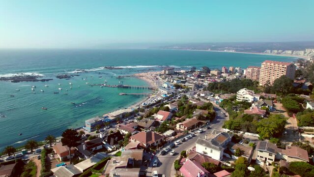 Aerial rotating shot of the port with boats docked within Algarrobo, Chile