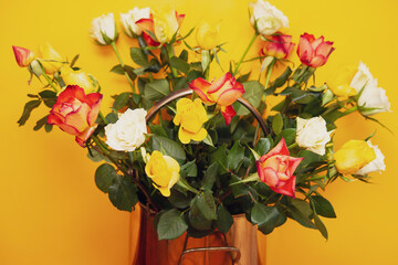 beautiful bouquet of multi-colored roses in a vintage metal bucket