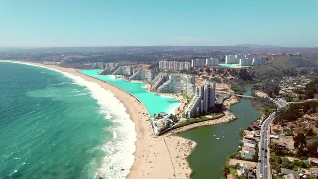 Aerial establishing shot of seafront resorts looking out onto Pejerrey beach in Chile