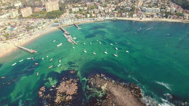 Slowmotion shot revealing boats docked off the coast of Pejerrey beach, Algarrobo