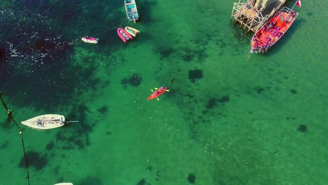 Slowmotion rotating shot of a couple kayaking from Pejerrey beach in Algarrobo