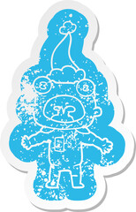 cartoon distressed sticker of a weird alien communicating wearing santa hat