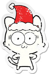 distressed sticker cartoon of a surprised cat wearing santa hat
