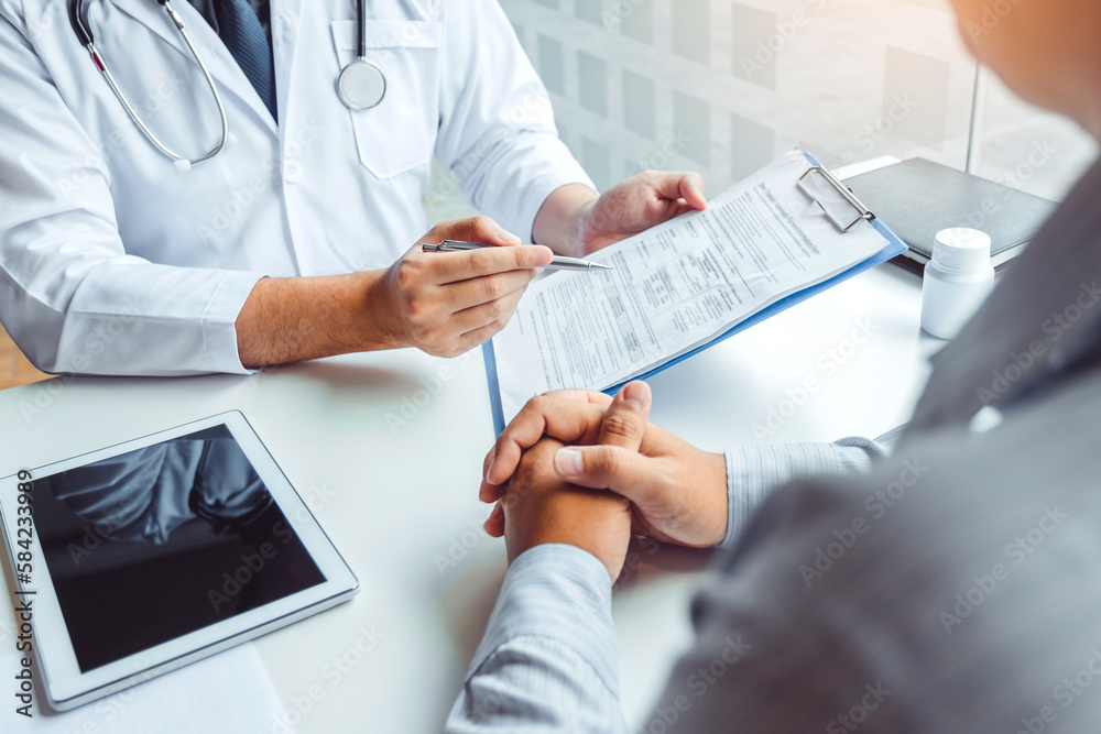 Wall mural doctors and patients consulting and diagnostic examining sit and talk. at the table near the window 