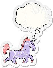 cartoon unicorn and thought bubble as a distressed worn sticker