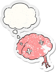 cartoon injured brain and thought bubble as a distressed worn sticker