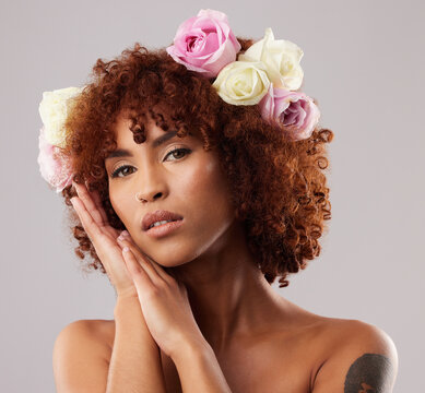 Portrait, skincare and flowers with a model woman in studio on a gray background for natural beauty. Wellness, luxury and face with an attractive young female wearing a flower crown or wreath