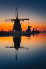 Fototapeta na wymiar Morning among the windmills in Kinderdijk - one of the most characteristic places in the Netherlands. The beautiful spring adds charm to this place.