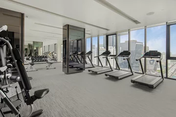 No drill light filtering roller blinds Fitness Modern gym interior with sport and fitness equipment overlooking building view , fitness center interior, interior of crossfit