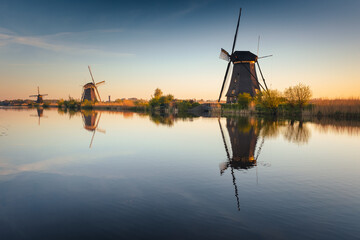 Morning among the windmills in Kinderdijk - one of the most characteristic places in the Netherlands. The beautiful spring adds charm to this place.