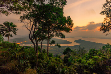 Panoramic nature background (mountains, sea, trees, twilight lights in the sky, waterfront communities), naturally blurred through the wind, seen on tourist spots or scenic spots