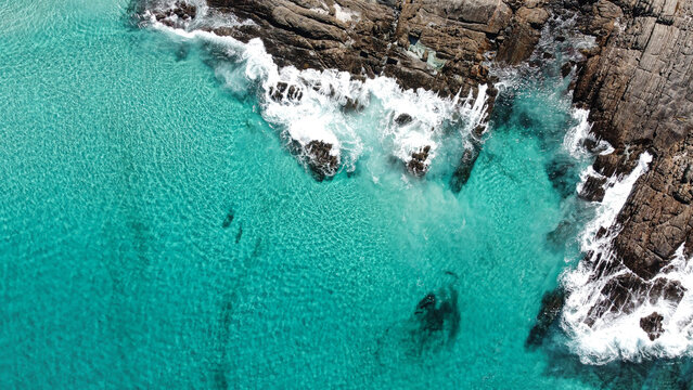 Aerial picture of blue water and rocks. Location Bremer Bay in South-west Australia. Drone view of ocean, rocks, small waves and foamy water. © Elsa