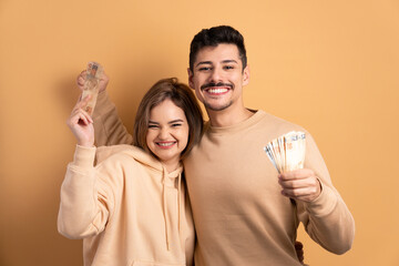 cheerful couple celebrating successful business money in studio shot. economy, payment, successful concept. 