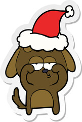 sticker cartoon of a tired dog wearing santa hat