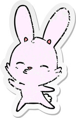 distressed sticker of a curious waving bunny cartoon