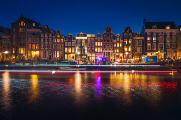 Canals in Amsterdam - the capital of the Netherlands in a night scenery. The huge amount of colors adds a beautiful look to this architecture.