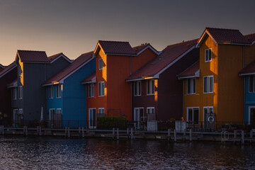 Colorful houses in Groningen during the blue hour. The original architecture of the houses is a...