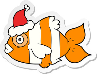 sticker cartoon of a exotic fish wearing santa hat