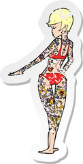retro distressed sticker of a cartoon bikini girl covered in tattoos