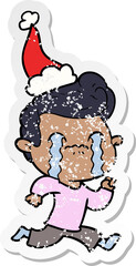 distressed sticker cartoon of a man crying wearing santa hat