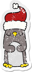 distressed sticker of a cartoon christmas penguin